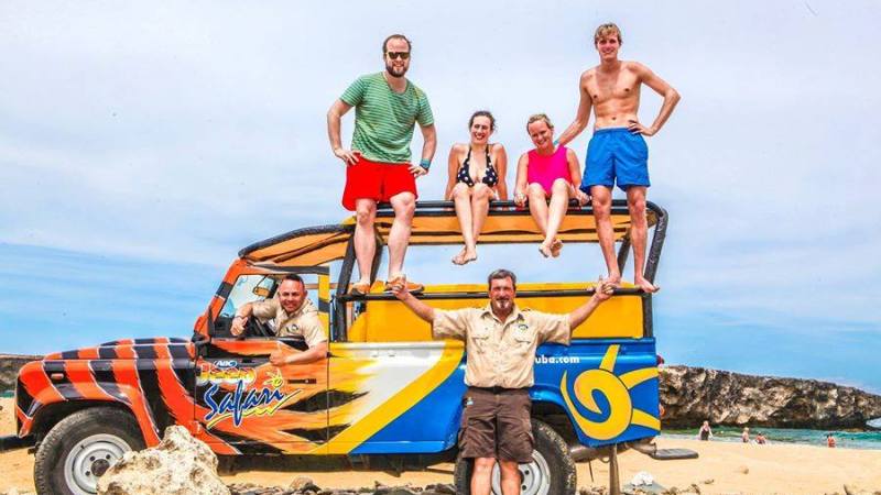 Jeep safari group posing around the vehicle